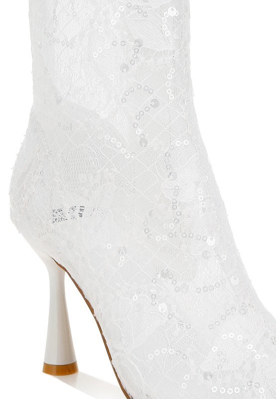 Close-up of white sheer lace ankle boot with sequin detailing
