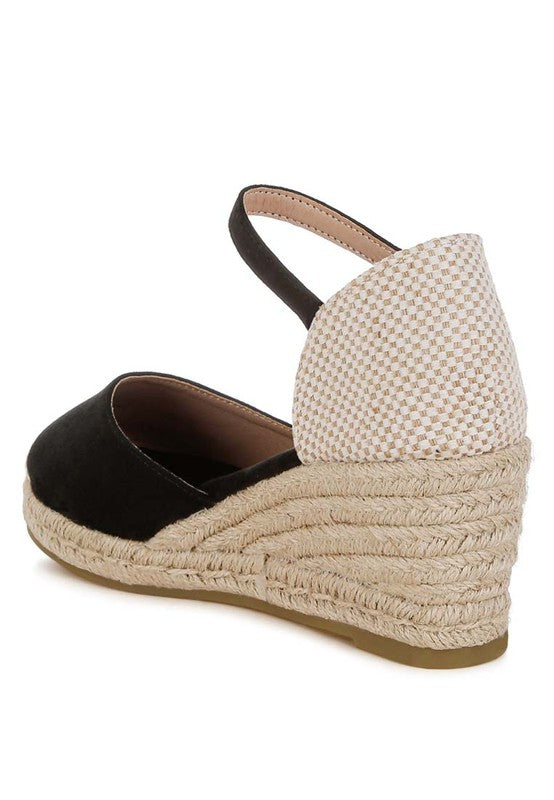 Black wedge heel espadrille with ankle strap and natural jute-wrapped heel – back view