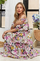 Model sitting in romantic floral tiered maxi dress
