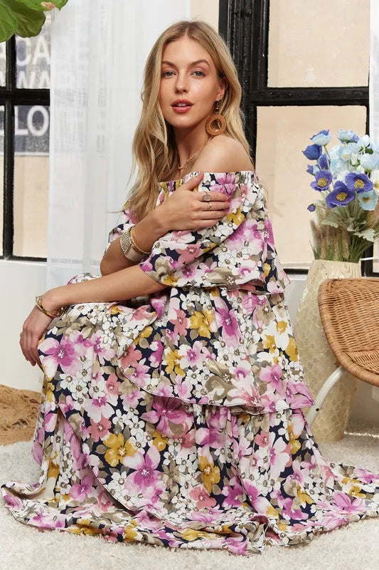 Model sitting in romantic floral tiered maxi dress
