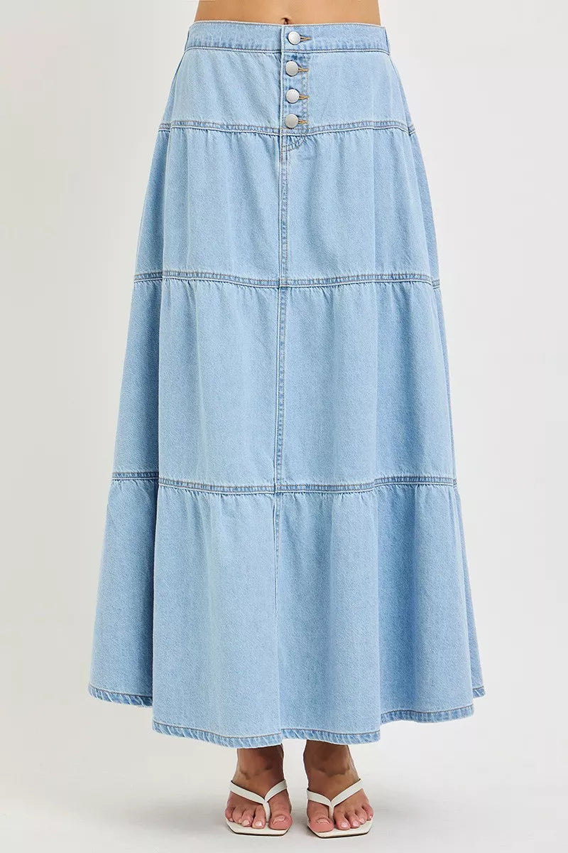 Front view of light blue tiered denim maxi skirt with button front detail
