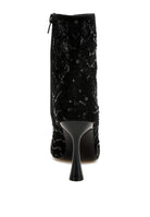 Back view of black lace ankle boot with zipper and sculpted heel