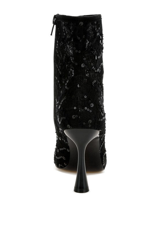 Back view of black lace ankle boot with zipper and sculpted heel