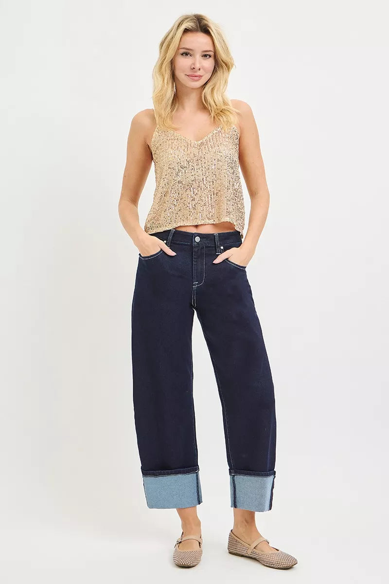 AVAH- Model wearing dark rinse cropped wide leg jeans with oversized contrast cuffs and classic five pocket styling.