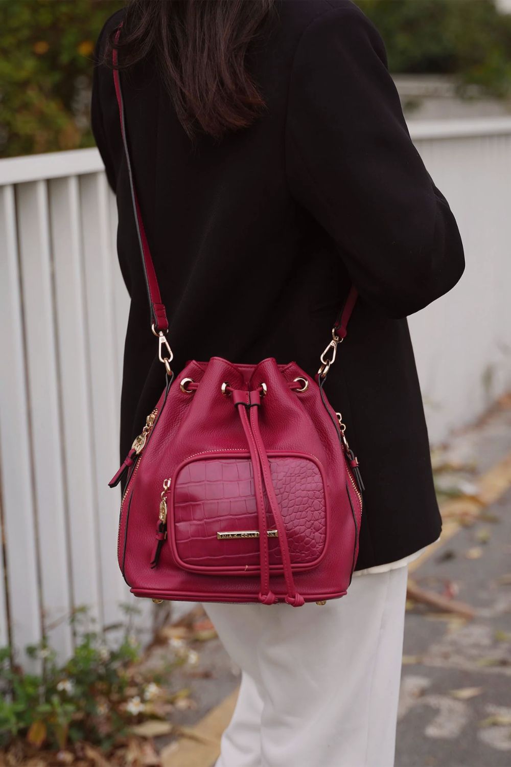 AVAH Handbags for Fall banner featuring a red textured handbag worn with a black blazer, chic women’s totes and crossbodies in seasonal tones