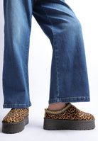 full outfit view of leopard print platform shoes and jeans
