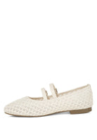 Beige raffia ballet flats with faux leather straps and double buckle detail, side angle.