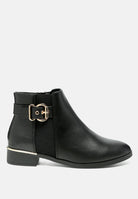 Black ankle boot with a gold buckle on a white background