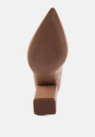 Close-up of a brown pointed-toe boot sole on a white background