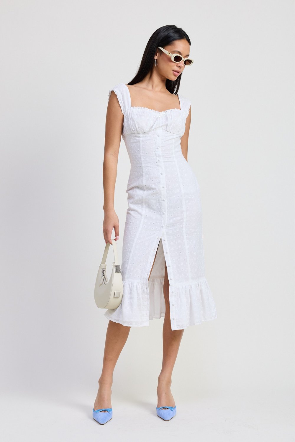 White button front midi dress with ruffle hem styled with blue heels and handbag