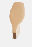 Beige wedge sandal with square toe on a white background, bottom view
