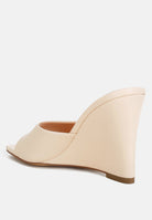 Beige wedge sandal with square toe on a white background back view