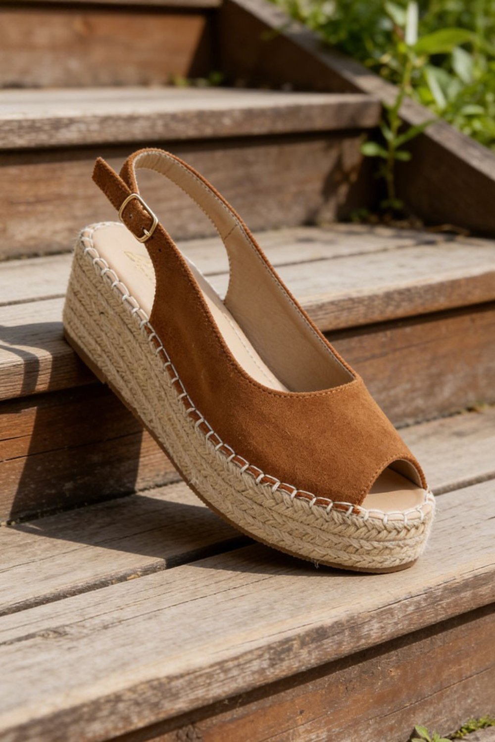 Brown suede slingback espadrille wedge sandal styled on wooden steps