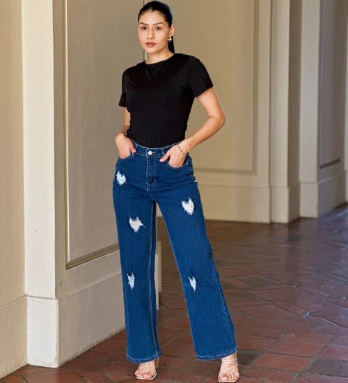 High-rise wide-leg jeans with distressed heart details styled with a black tee, by AVAH