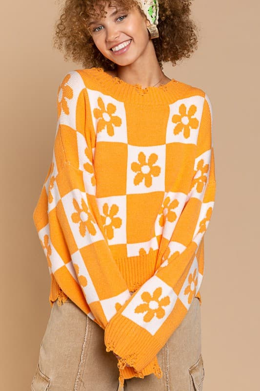 Our most popular style, this oversized sweater top is crafted with a round neckline and long sleeves for easy layering. A unique flower and checkerboard pattern creates an eye catching look. Ribbed edges add graphic detail and make it easy to pair with your favorite jeans or leggings. The irresistible oversized fit will never go out of style! Avah Couture