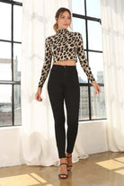 A must have in your wardrobe, this crop top features a mock neck and open back with string closure. The leopard print adds a sexy twist to any outfit. Wear it with your favorite jeans and heels for an after work parry or dress it up with a skirt for a night on the town! Leopard print. Avah Couture