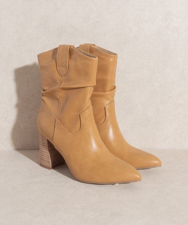 A city slick cowgirl bootie, with a flared heel and minimalist details. With a pointed toe, this slip on bot is sure to be your favorite wardrobe staple.