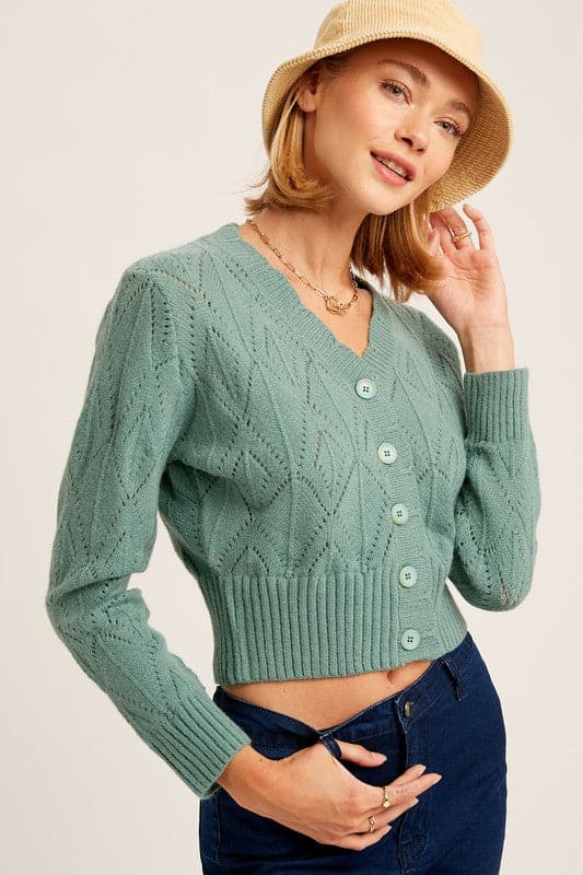 Add some sophistication to your wardrobe with the scallop edge cardigan sweater. This piece boasts charming crochet detailing and scalloped neckline. Featuring ribbed cuffs and hem, it pairs perfectly with jeans and ankle boots for a polished look. Avah Couture