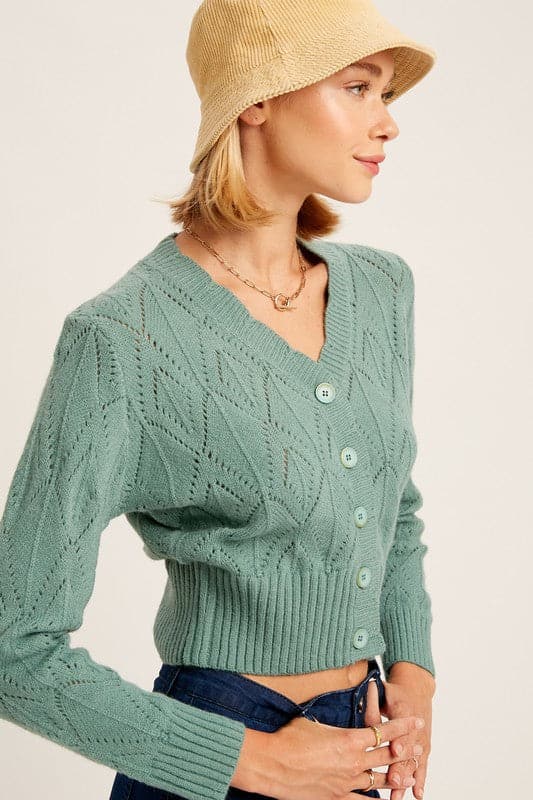 Add some sophistication to your wardrobe with the scallop edge cardigan sweater. This piece boasts charming crochet detailing and scalloped neckline. Featuring ribbed cuffs and hem, it pairs perfectly with jeans and ankle boots for a polished look. Avah Couture