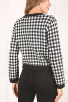 A classic piece that has timeless style, the Black And White Check Jacket is a must have this season. The heavy weight knit fabric features a black and white check pattern that gives it its name. A perfect balance of comfort and style, this jacket features 4 front snap buttons and 2 functional pockets. Wear it with your favorite outfit to work or play a classic piece to get you through any occasion! Avah Couture