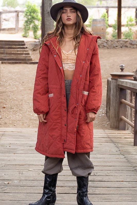 A long padded jacket with hood is an essential for your fall and winter wardrobe! The warm, cozy style of this long padded jacket will make it difficult to take off once you put it on.This soft and comfortable coat features a hoodie and contrast stitching on the pocket and shoulder. Button and zipper closure makes it easy to get in and out of while keeping you cozy. With its relaxed fit, this coat will keep you warm on cold days. A must have for every woman’s wardrobe! Avah Couture