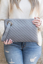 Classic and timeless, this beautifully quilted design clutch will be your go to bag. You’ll love it so much you’ll want one in every color! Made with a premium soft quilted PU leather and cotton Herringbone print lining and complete with grommet detail and wristlet. Avah Couture