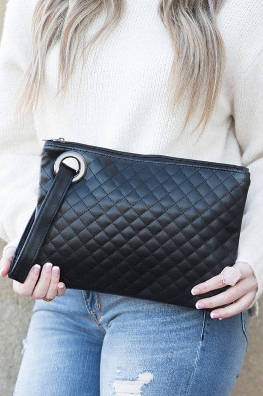 Classic and timeless, this beautifully quilted design clutch will be your go to bag. You’ll love it so much you’ll want one in every color! Made with a premium soft quilted PU leather and cotton Herringbone print lining and complete with grommet detail and wristlet. Avah Couture