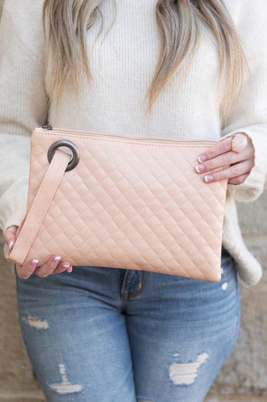 Classic and timeless, this beautifully quilted design clutch will be your go to bag. You’ll love it so much you’ll want one in every color! Made with a premium soft quilted PU leather and cotton Herringbone print lining and complete with grommet detail and wristlet. Avah Couture