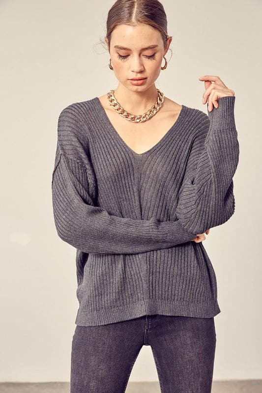 This comfy v neck knit top is the perfect transitional pice for all your fall outfits. Layer it over a cozy tank top and jeans or shorts for the weekend, or under a jacket when the fall weather settles in. This easy to style, chic knit pullover will look great with any wardrobe. Avah Couture