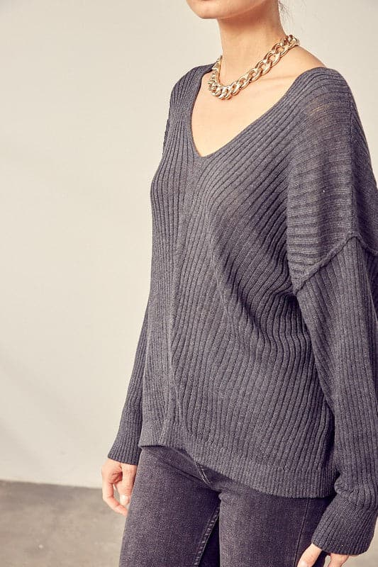 This comfy v neck knit top is the perfect transitional pice for all your fall outfits. Layer it over a cozy tank top and jeans or shorts for the weekend, or under a jacket when the fall weather settles in. This easy to style, chic knit pullover will look great with any wardrobe. Avah Couture