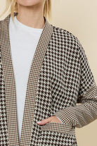 Show off your laid back style in our Lou Lou for You cardigan. The Houndstooth pattern and open front are the perfect combo for a stylish cardigan. Made of soft, poly spandex blend lightweight fabric, it features an open front and two front pockets. A collarless cardigan is also perfect for layering over any outfit. We love it with a crew neck tee shirt or tank, black jeans & boots for the perfect weekend look! Avah Couture