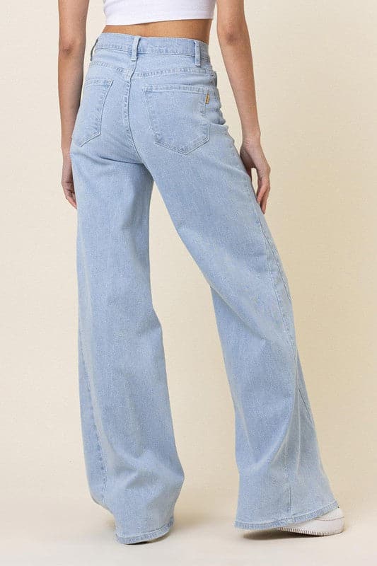 This pair of low-rider, wide-fit jeans brings a modern take to the classic staple. Featuring an added cut piece on the sides, a 5-pocket construction and zip fly closure these trendy jeans will quickly become your go-to pants for the season. - Avah Couture