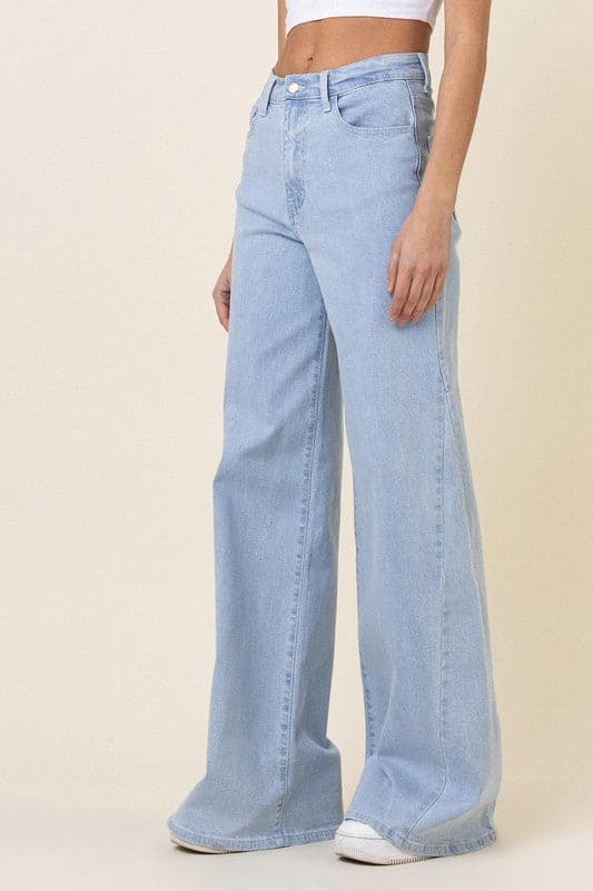 This pair of low-rider, wide-fit jeans brings a modern take to the classic staple. Featuring an added cut piece on the sides, a 5-pocket construction and zip fly closure these trendy jeans will quickly become your go-to pants for the season. - Avah Couture