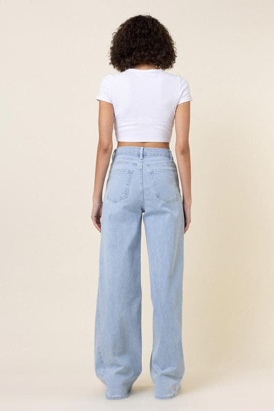 This pair of low-rider, wide-fit jeans brings a modern take to the classic staple. Featuring an added cut piece on the sides, a 5-pocket construction and zip fly closure these trendy jeans will quickly become your go-to pants for the season. - Avah Couture