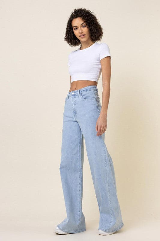 This pair of low-rider, wide-fit jeans brings a modern take to the classic staple. Featuring an added cut piece on the sides, a 5-pocket construction and zip fly closure these trendy jeans will quickly become your go-to pants for the season. - Avah Couture