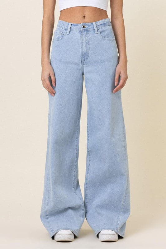 This pair of low-rider, wide-fit jeans brings a modern take to the classic staple. Featuring an added cut piece on the sides, a 5-pocket construction and zip fly closure these trendy jeans will quickly become your go-to pants for the season. - Avah Couture
