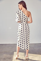 Add a chic touch to your spring wardrobe with this one-shoulder polka dot wrap dress. This on-trend piece features a classic silhouette that is simple, sleek, and sophisticated. This dress is perfect for work or the weekend and looks great paired with heels or flats! Avah Couture