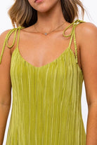 Avah Couture - Step out in style with this lettuce hem colorful mini dress with delicate tie shoulder straps, a v-neckline, and a ribbed texture. It features an on-trend lilac purple or lime green color palette that’s perfect for the season! Pair this dress with your favorite wedge heels or sandals to complete the look.  Ribbed Sleeveless V-neck Tie straps Lettuce hem Mini length- Lime Green
