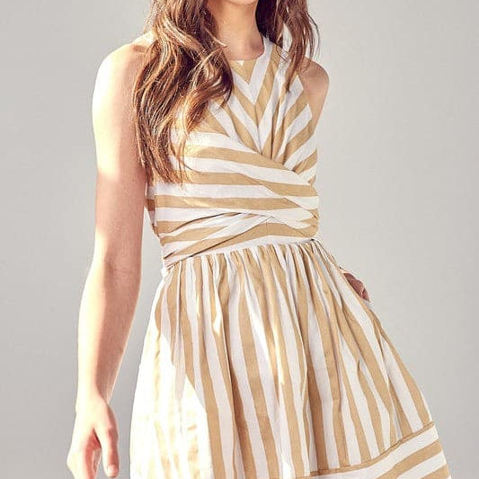 This striped mini dress will be your go to style for all seasons. The front cross and back tie create an easy fit and a flattering silhouette, while the pockets add extra style points. This sleeveless design is great for work or play and easily dresses up with a blazer and heels or down with a cardigan and sandals. Avah Couture