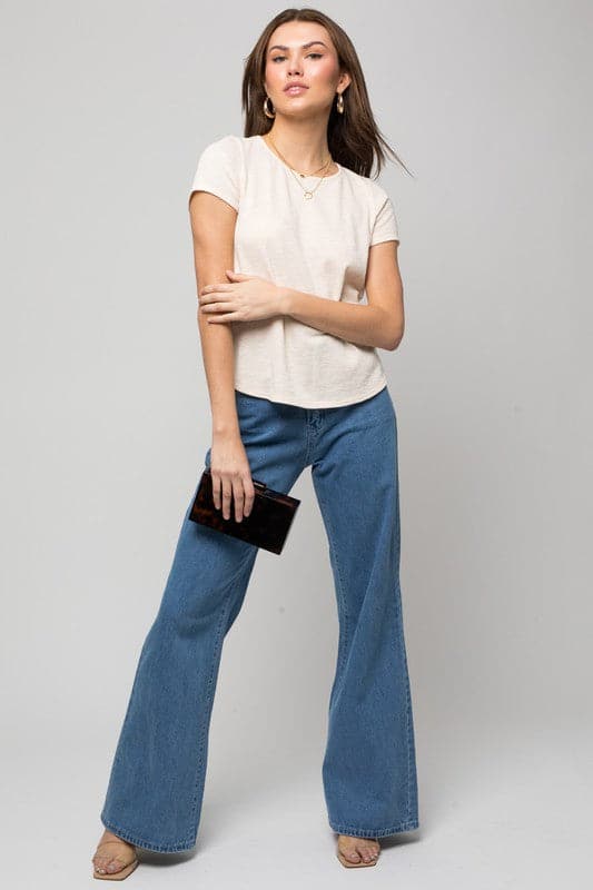 Look your best in this essential tee. It’s feminine, flattering and simple everything you. Need to make a statement. A round neckline and short sleeves give this piece a modern look while the back button detail adds interest. Wear it with your favorite pair of jeans or casual pants for an effortless style.