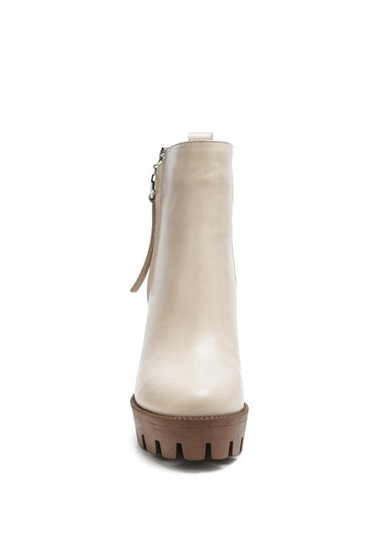 A must have for your fall and winter outfits, this pair of very stylish high heel boots will give you a fashion edge. With a block heel, pointy toe and side zipper detail, this boot is a show stopper. Crafted with quality materials, this ankle boot can be used for many season to come. Avah Couture