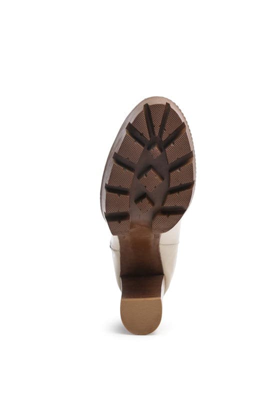A must have for your fall and winter outfits, this pair of very stylish high heel boots will give you a fashion edge. With a block heel, pointy toe and side zipper detail, this boot is a show stopper. Crafted with quality materials, this ankle boot can be used for many season to come. Avah Couture