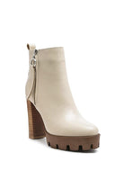 A must have for your fall and winter outfits, this pair of very stylish high heel boots will give you a fashion edge. With a block heel, pointy toe and side zipper detail, this boot is a show stopper. Crafted with quality materials, this ankle boot can be used for many season to come. Avah Couture