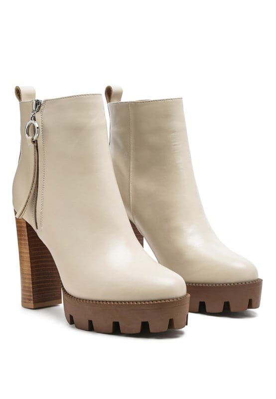 A must have for your fall and winter outfits, this pair of very stylish high heel boots will give you a fashion edge. With a block heel, pointy toe and side zipper detail, this boot is a show stopper. Crafted with quality materials, this ankle boot can be used for many season to come. Avah Couture