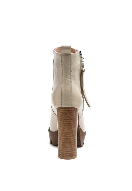 A must have for your fall and winter outfits, this pair of very stylish high heel boots will give you a fashion edge. With a block heel, pointy toe and side zipper detail, this boot is a show stopper. Crafted with quality materials, this ankle boot can be used for many season to come. Avah Couture