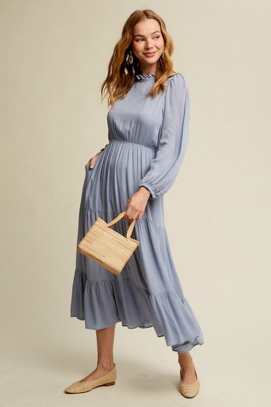 This swing dress is the perfect easy chic fall fashion. The round neckline is accented with ruffle detail for a flattering look. The long sleeves have a comfortable elastic band for a custom fit. The key hole closure on the back adds feminine flair and sleek style. The tiered bottom layer adds elegance to this piece, while the clean hem completes the look. You can easily wear this maxi dress anywhere! Avah Couture