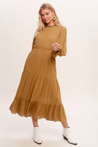 This swing dress is the perfect easy chic fall fashion. The round neckline is accented with ruffle detail for a flattering look. The long sleeves have a comfortable elastic band for a custom fit. The key hole closure on the back adds feminine flair and sleek style. The tiered bottom layer adds elegance to this piece, while the clean hem completes the look. You can easily wear this maxi dress anywhere! Avah Couture