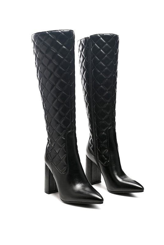Winter season is the perfect time to step into a pair of stylish, chic and elegant boots. The knee high block heeled boot is sophisticated footwear to have. This elegant pointed toe boot in block heel comes with side zipper opening and made in high quality soft PU. These high boots are quilted and have a supreme finish. Avah Couture