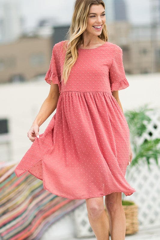 This flowy little dress is made from a textured chiffon that drapes beautifully, showing off your curves and making you feel extra cute. The ruffle sleeve detail adds femininity, while the button back provides coverage. An elastic shirred waist and side slits add an element of comfort and style. Easily transition from work to play with this gorgeous dress! Avah Couture