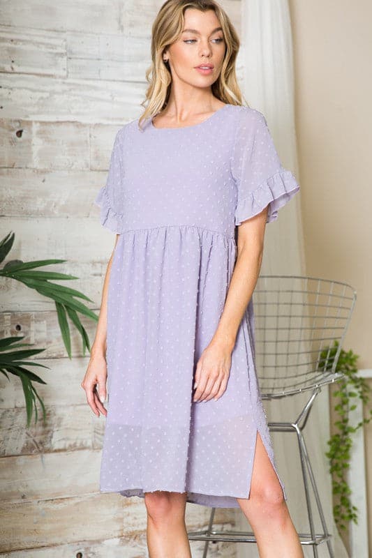 This flowy little dress is made from a textured chiffon that drapes beautifully, showing off your curves and making you feel extra cute. The ruffle sleeve detail adds femininity, while the button back provides coverage. An elastic shirred waist and side slits add an element of comfort and style. Easily transition from work to play with this gorgeous dress! Avah Couture